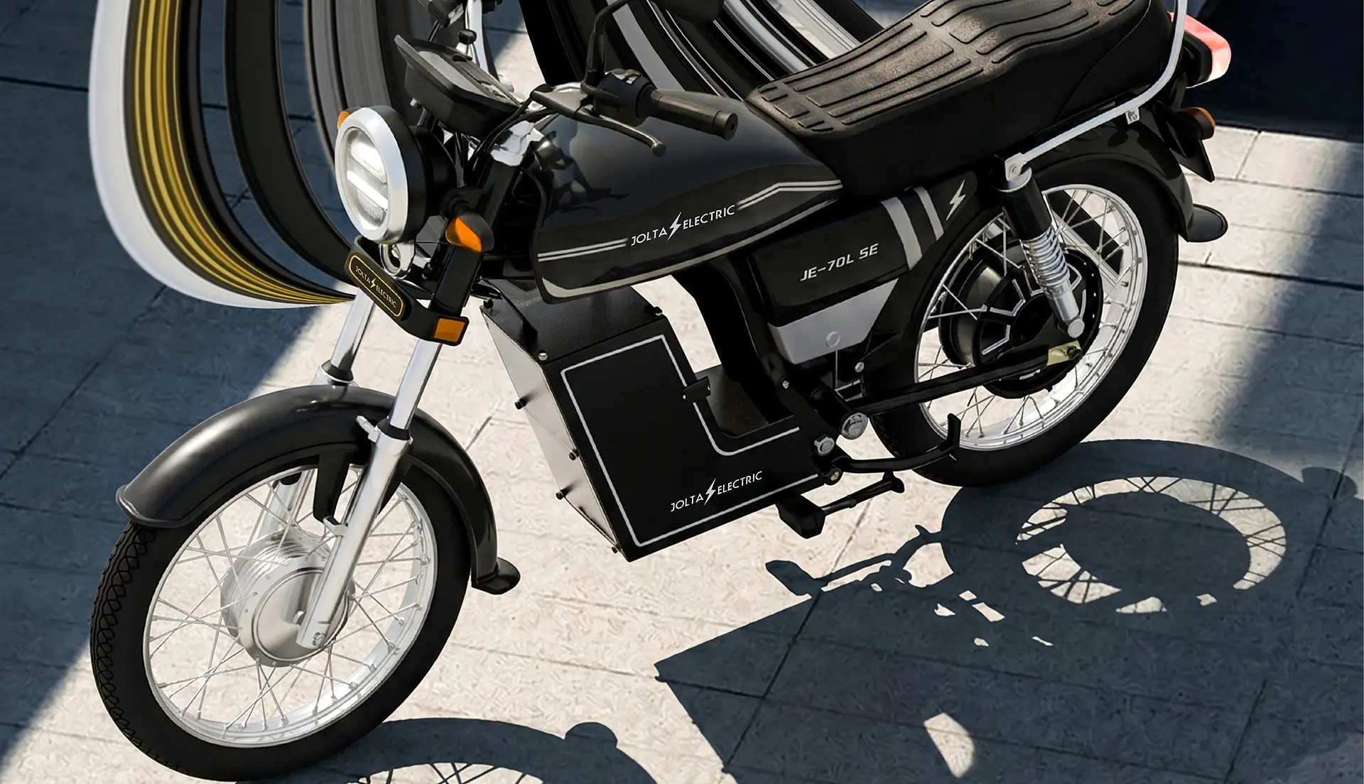 Jolta JE-70L SE Bolt electric motorcycle in black, casting a long shadow on stone paving