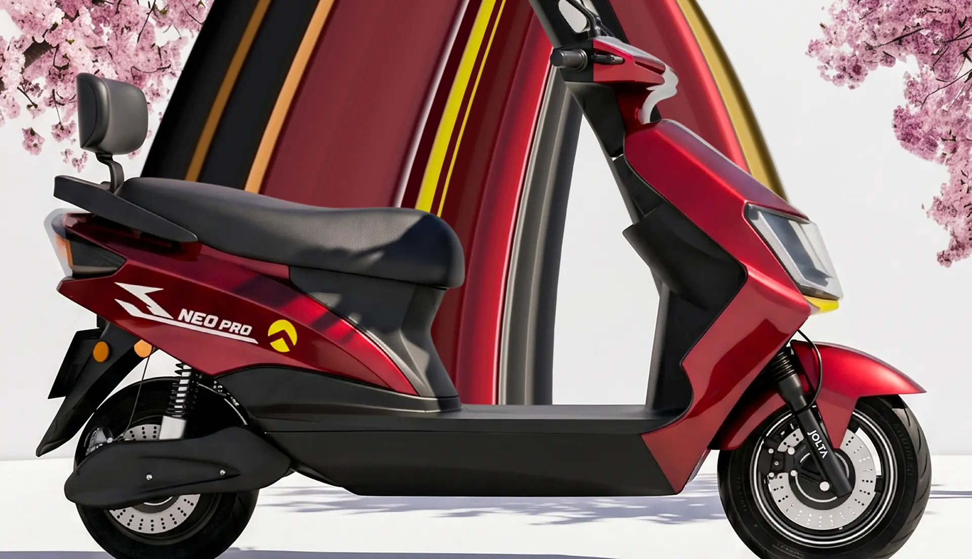 Jolta Neo Pro electric scooty in red, in front of a sweeping striped arch and cherry blossoms