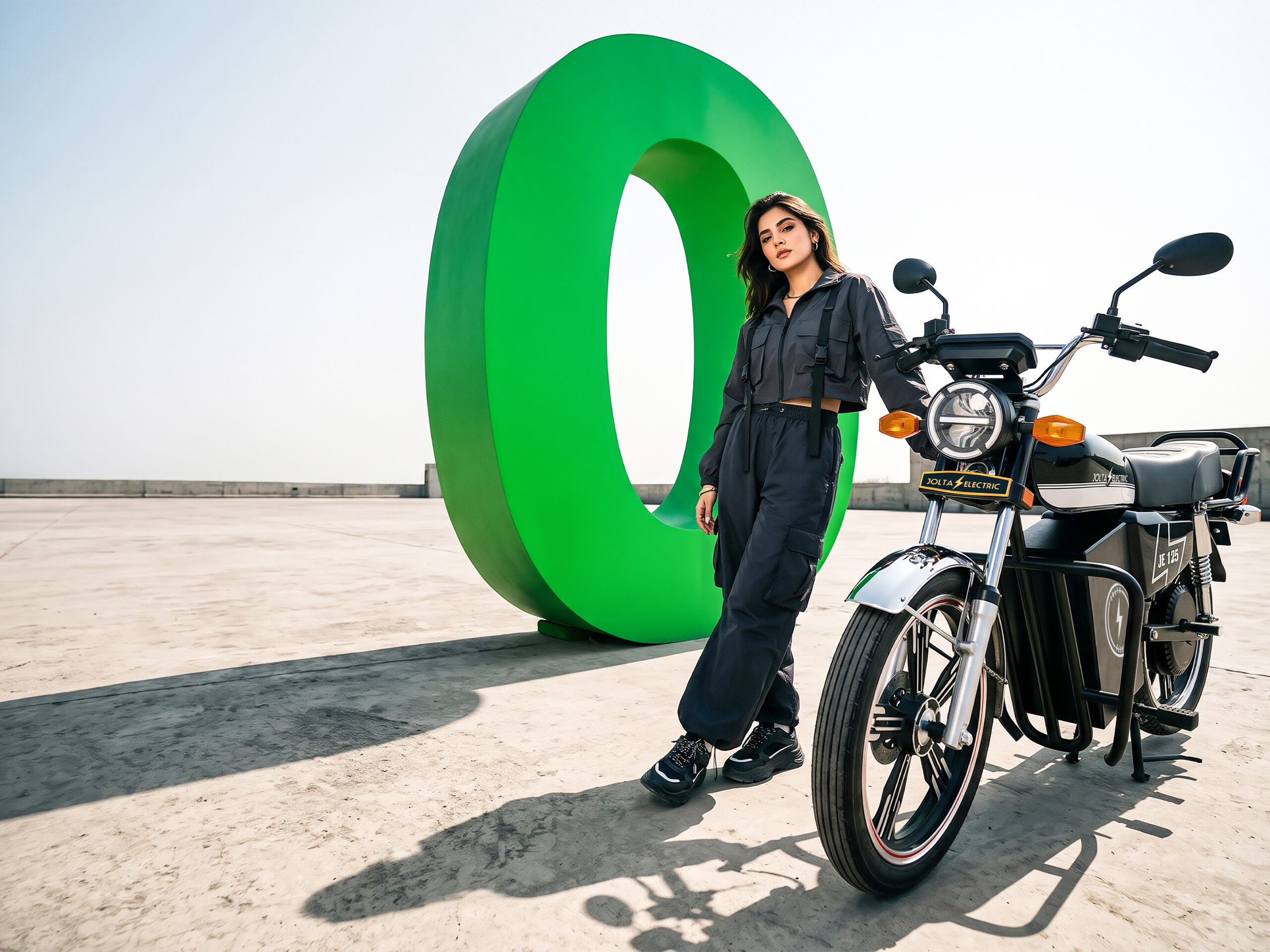 Woman beside a black Jolta JE-125L and a large green zero